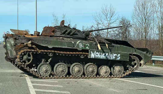 abandoned Russian tank tagged with the word “Wolverines”