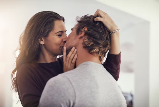a man and a woman kissing