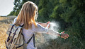 woman spraying insect repellent